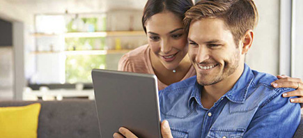 Couple shopping on tablet.